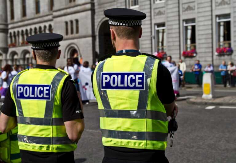 Police Officers Watching The Crowd. Uk Police
