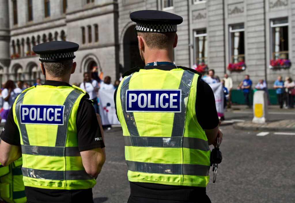 Police Officers Watching The Crowd. Uk Police