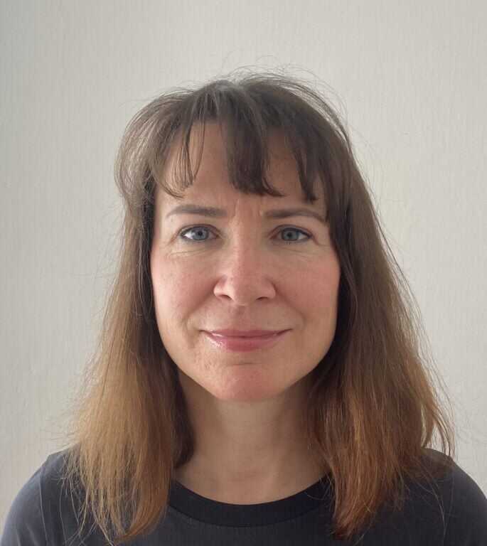 Iva Hendrych female with shoulder length brown hair and green eyes